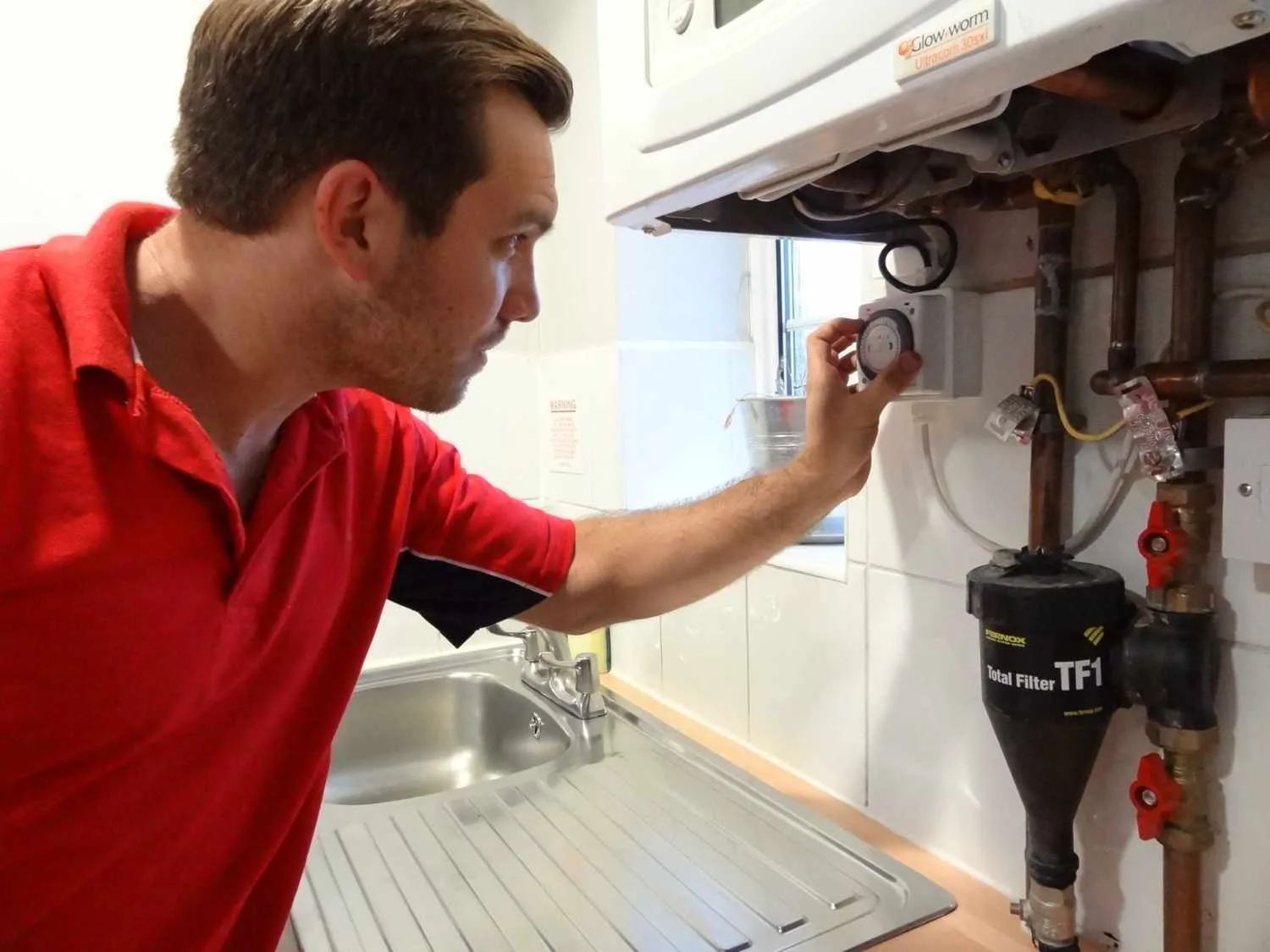 Loughton Plumbers boiler repair engineer working on a boiler in Loughton